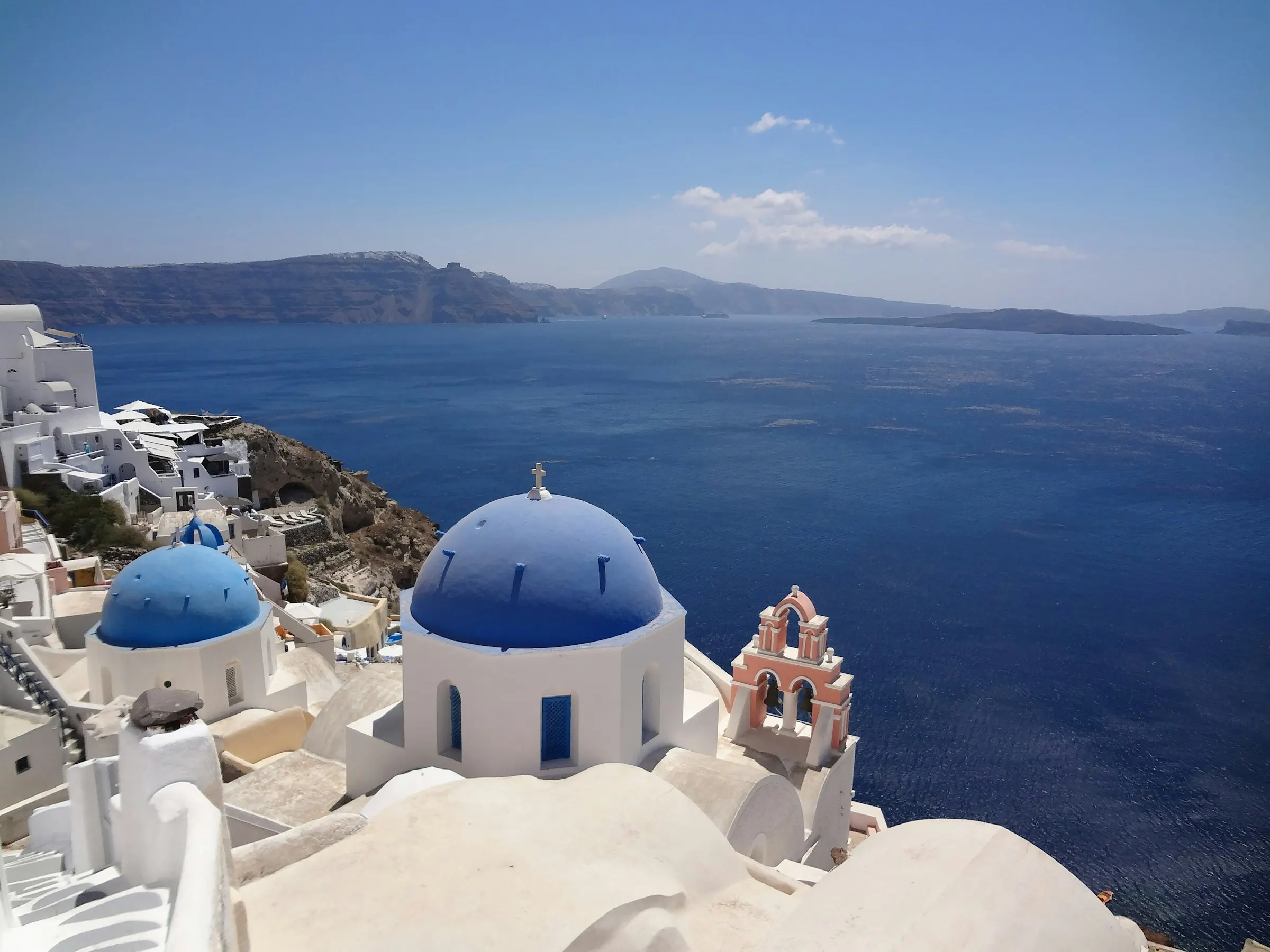 Blue domes and whitewashed rooftops above the caldera