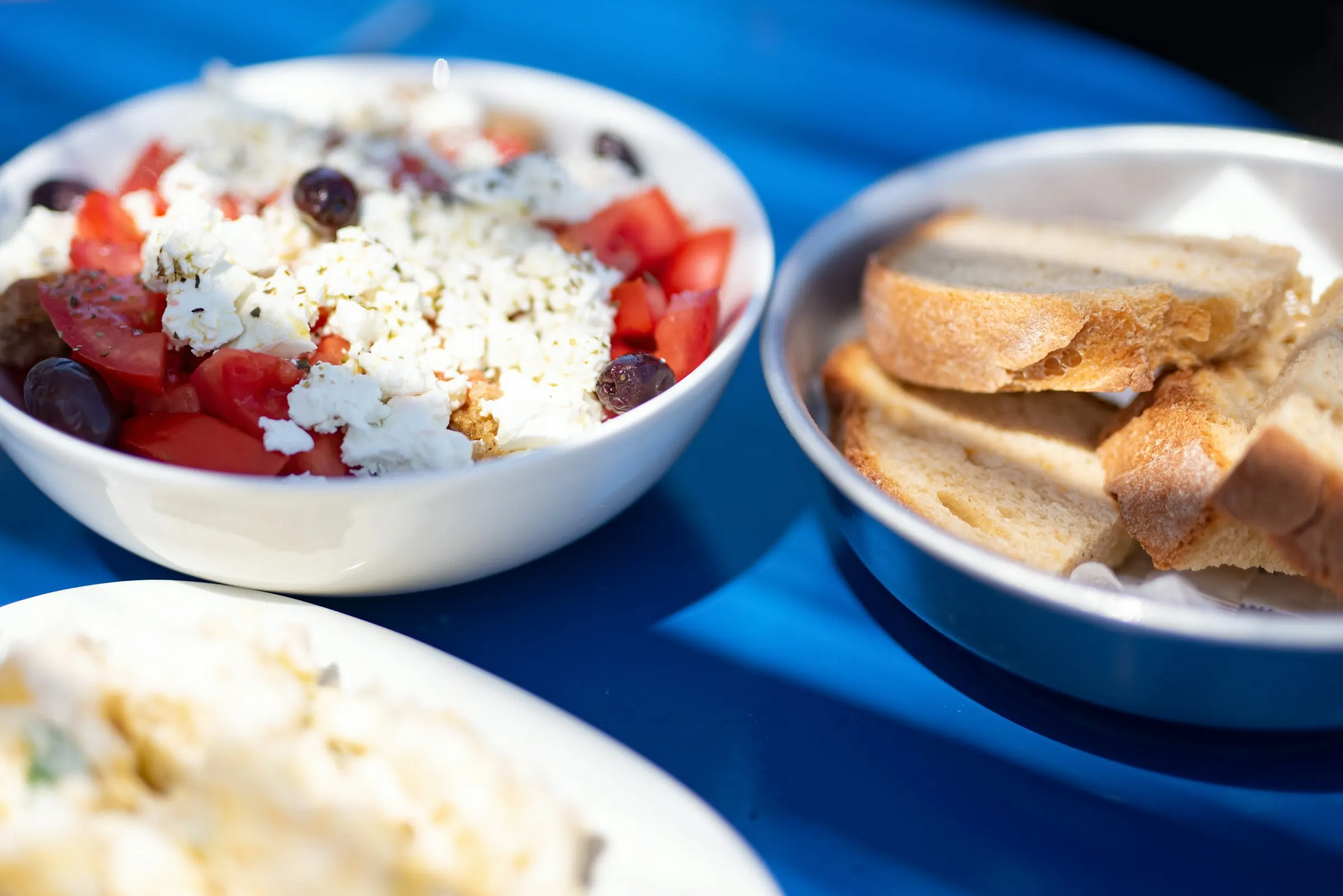 Greek breakfast bowls on a blue table