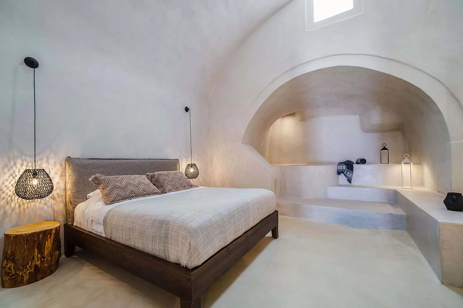 Cave suite bedroom with arched niches and soft lighting