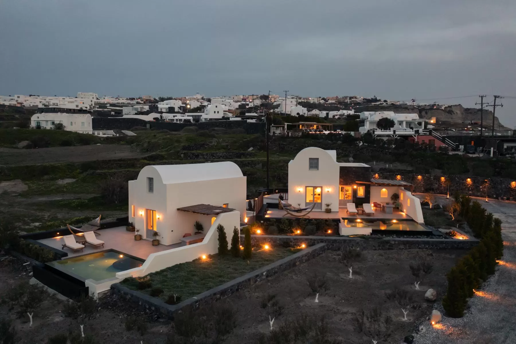 The villas lit up in the evening landscape of Oia