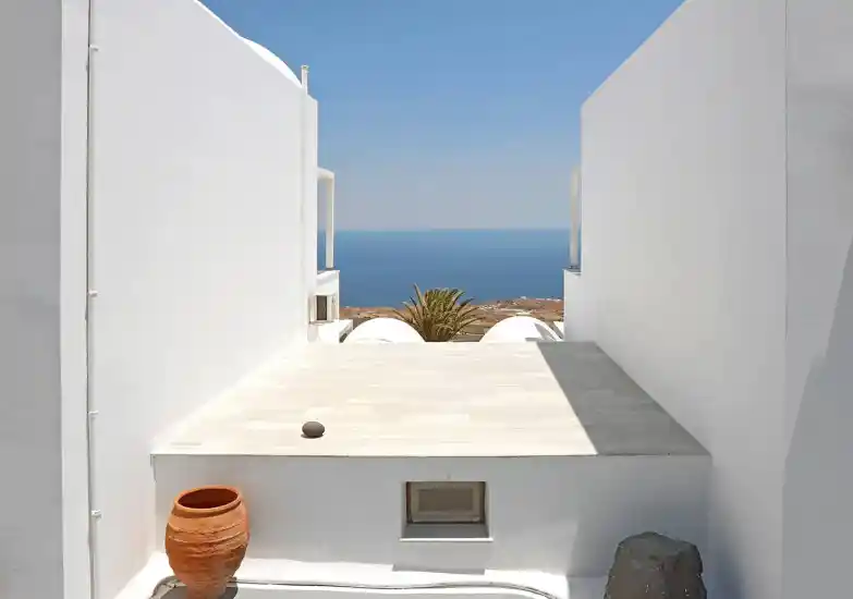 Whitewashed terrace with a sea view at Phaos Santorini Suites
