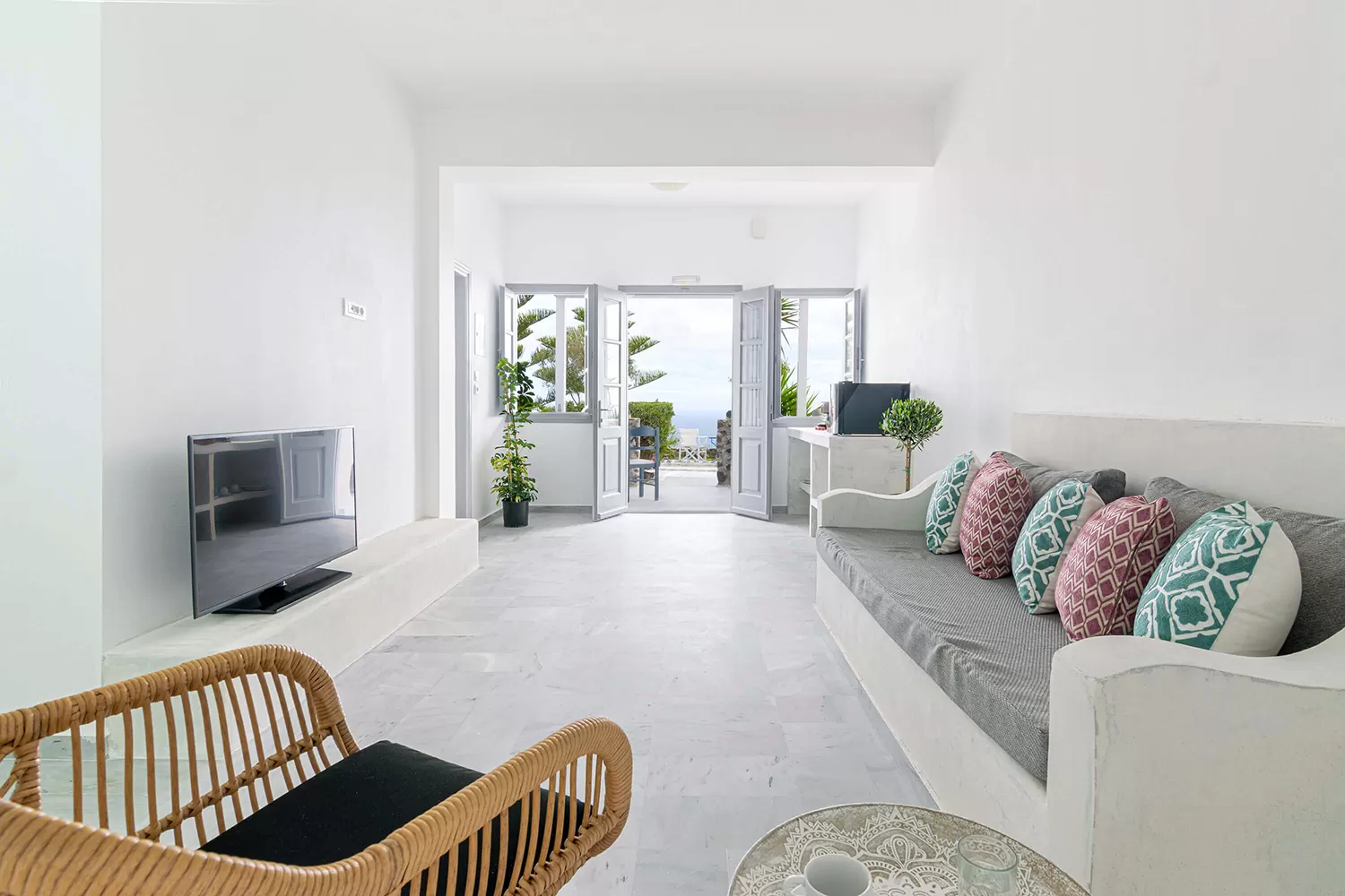 Bright living area of a renovated suite opening onto the veranda